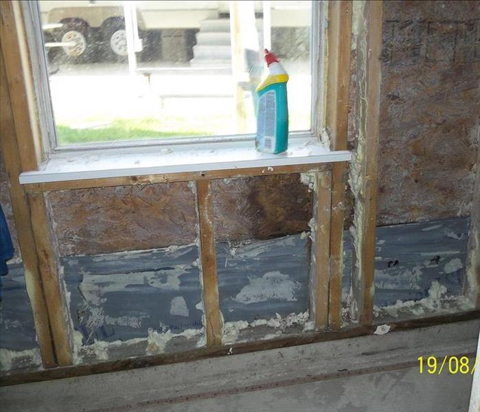 window with sheetrock removed around it 
