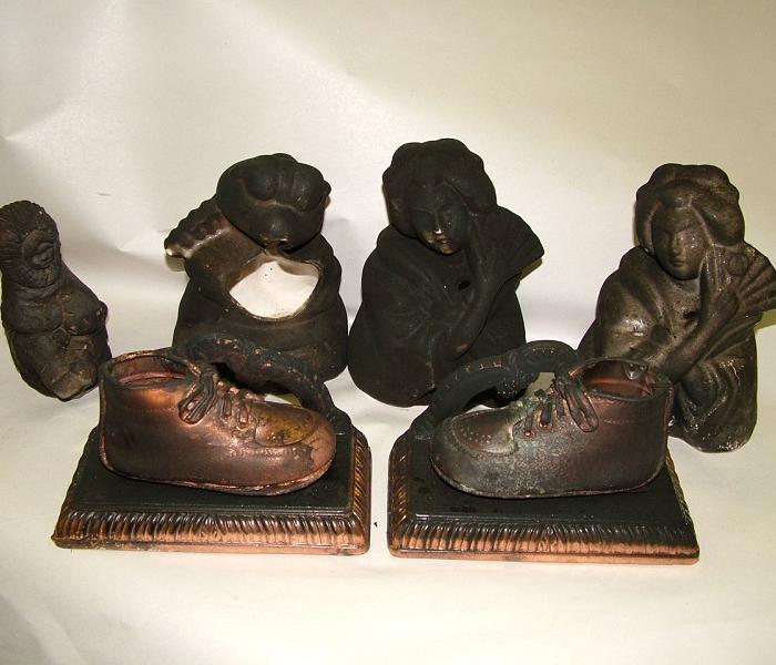 ceramic figurines and gold plated baby shoes covered in black soot