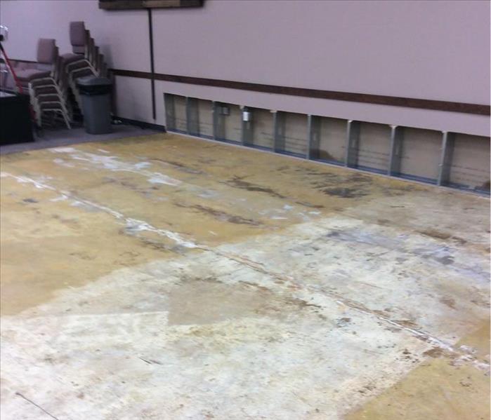 concrete floor after carpet was ripped up and a flood cut along the back wall of two feet by ten feet 