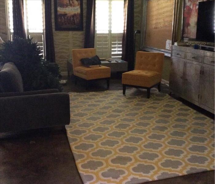 cleaned living room with yellow and gray rug, gray couch, and yellow chairs