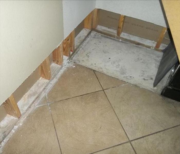 baseboards removed in corner of room with tile flooring