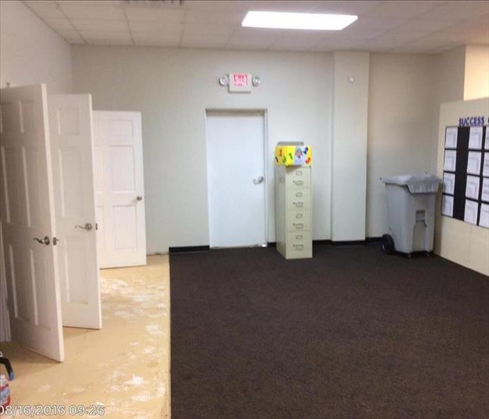 rooms with three white doors open, one filing cabinet, one trash can and carpeted floors 