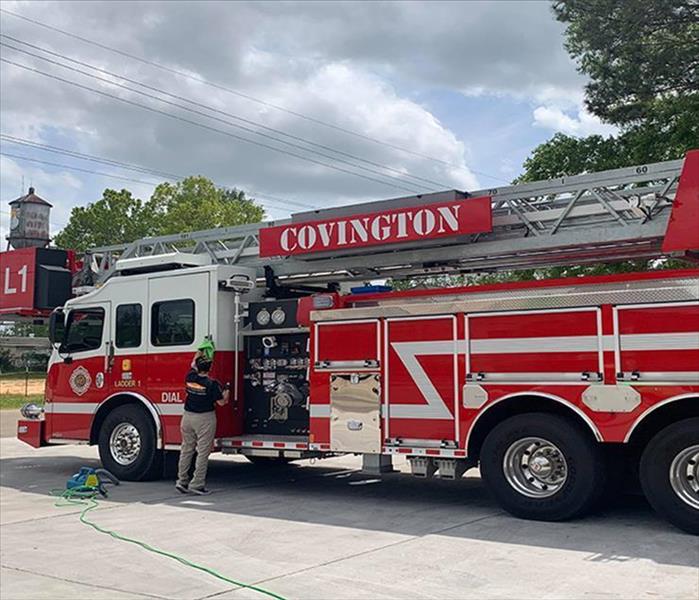 SERVPRO technician cleaning outside of fire truck
