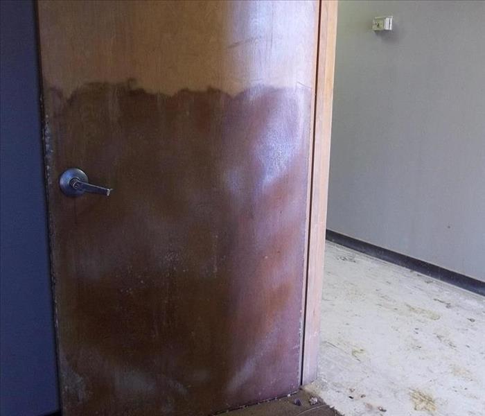 brown door with water line halfway up it 