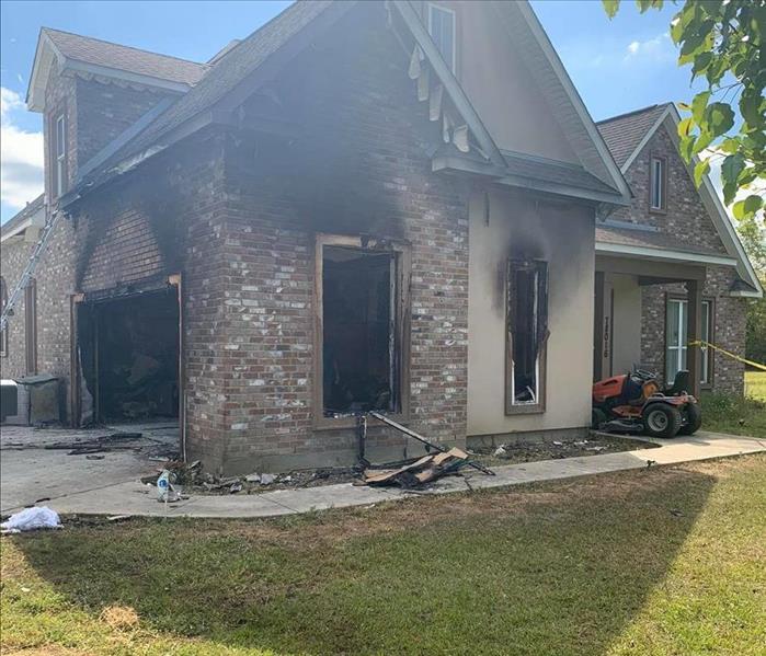 one story home that has significant fire damage to garage and right side of home