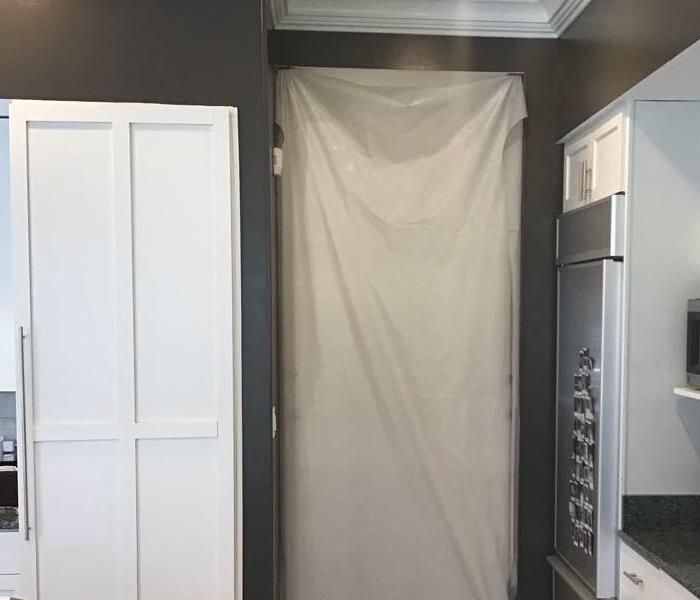 Kitchen with containment hanging in doorway 