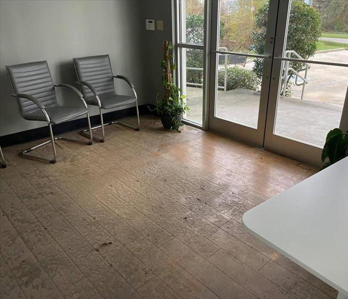 office foyer with debris from flood on flooring