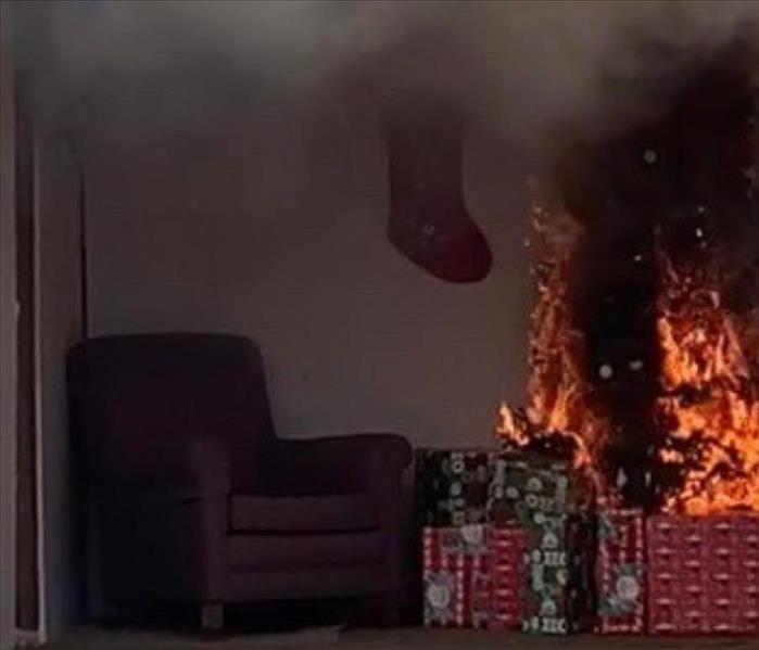 christmas tree on fire with presents under the tree